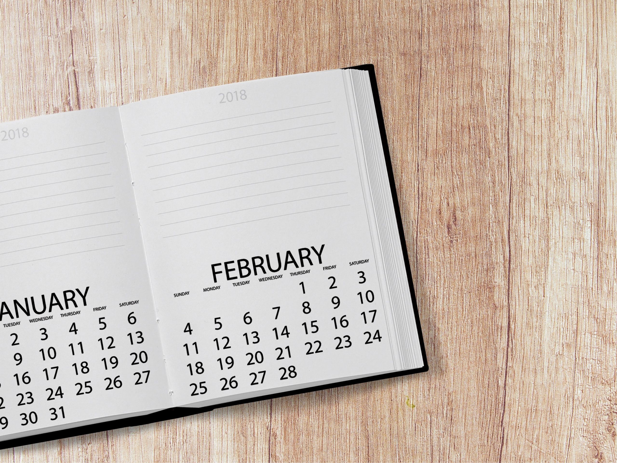 Monthly calendar book open showing the month as February and year as 2018