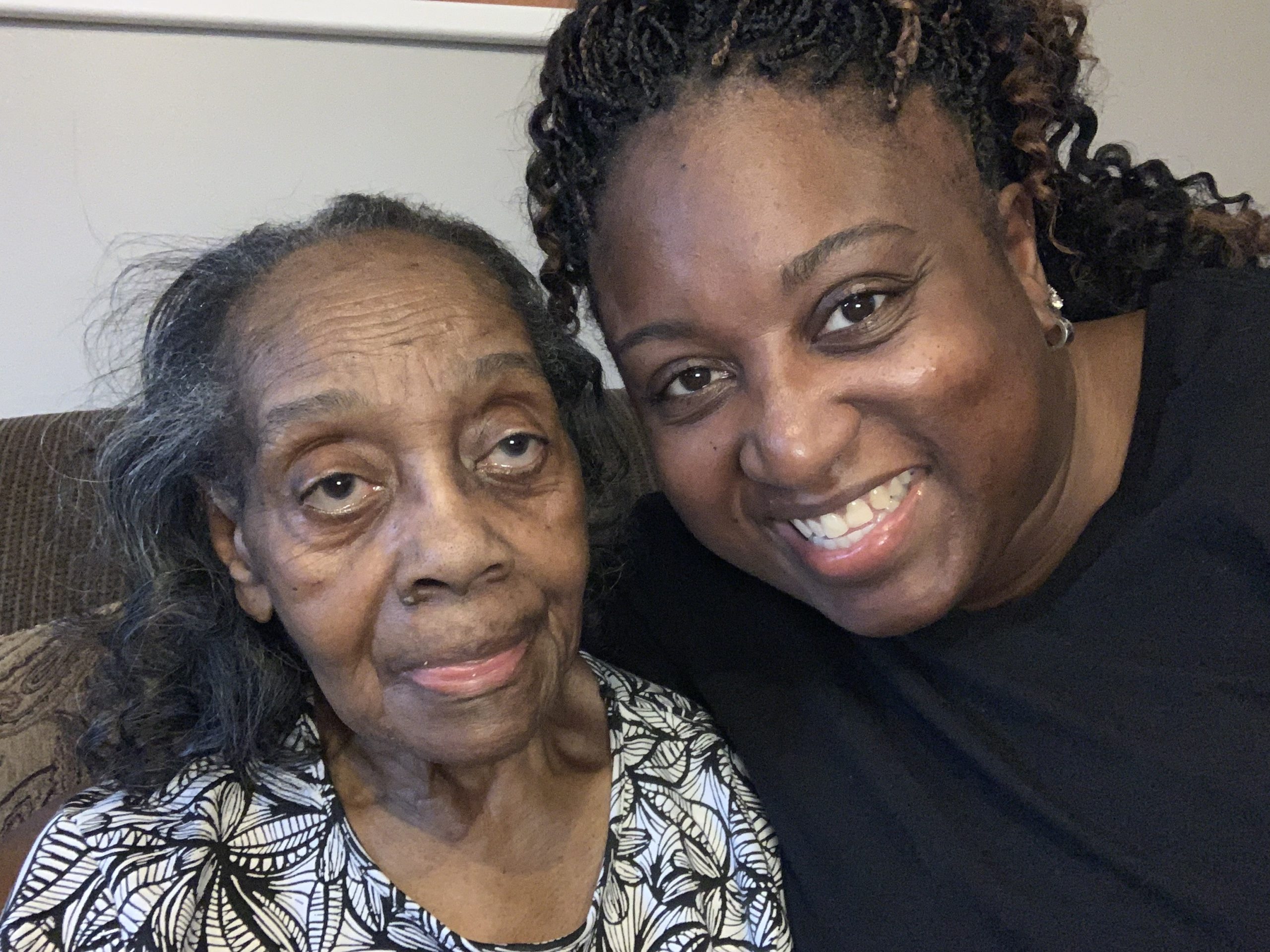 Older woman taking a selfie with her granddaughter