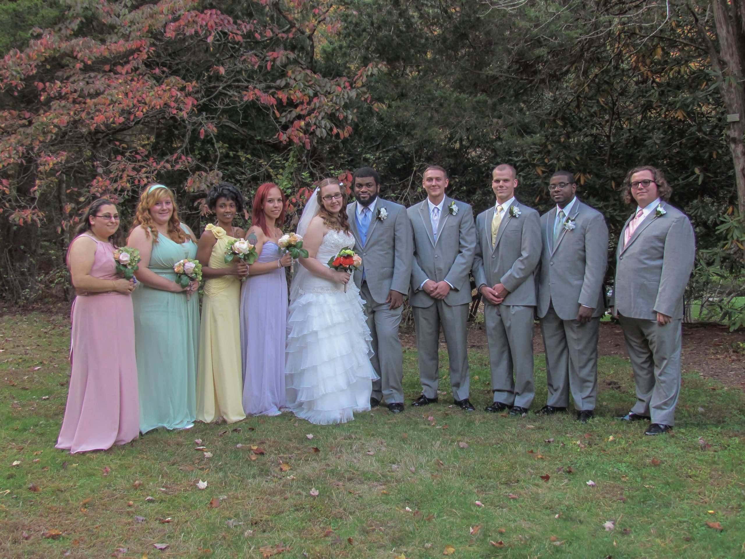 Bride & Groom surrounded on both sides by their bridesmaids and groomsmen